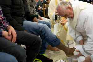 Pope Francis washing the feet of youth detainees on Holy Thursday.  