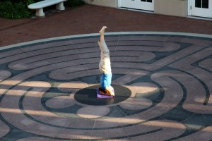 Prof. Susanne Scholz, doing yoga in the center of a labyrinth