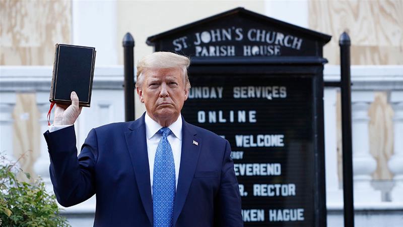 Donald Trump holds a Bible as he visits outside St John's Church across Lafayette Park from the White House on Monday, June 1, 2020, in Washington, DC. Part of the church was set on fire during protests on Sunday night [Patrick Semansky/AP Photo]